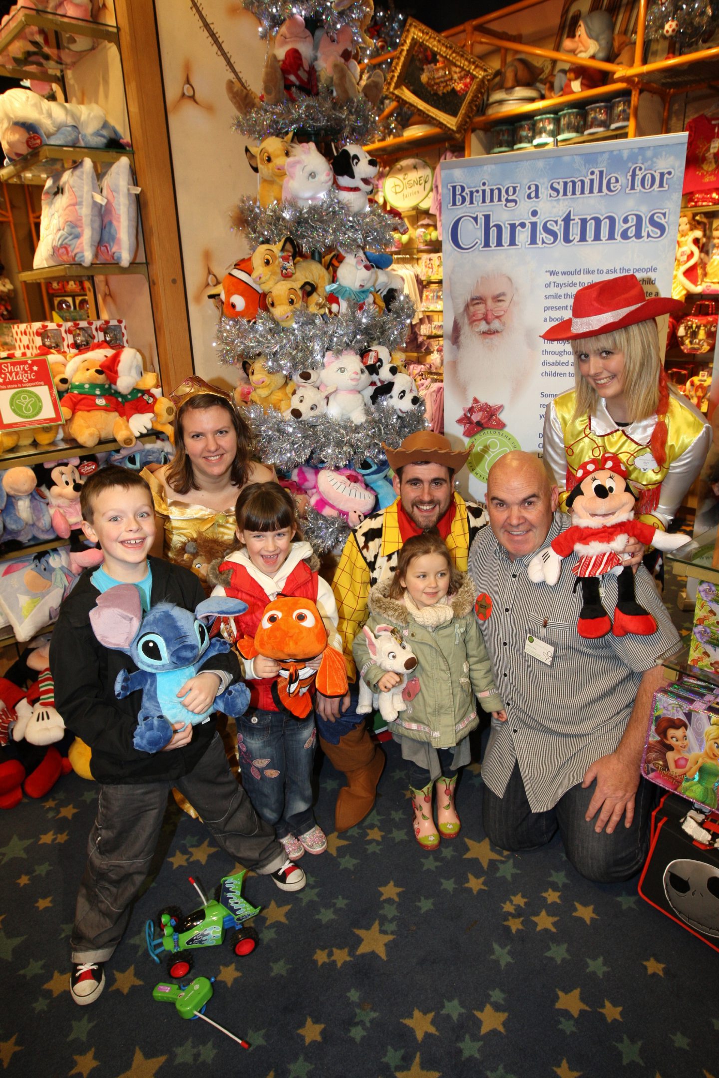 Shop staff in costume and kids inside the store as part of its drive to get people to sponsor a toy in 2010. 