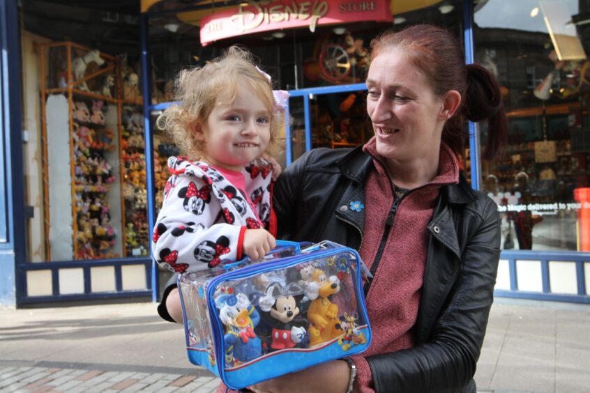 Lilly Johnstone and mum Cheryl with a new toy before the Dundee Disney store closed. 