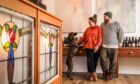 Nic and Stephen in their new shop and bar in Dundee with their dog Rita.