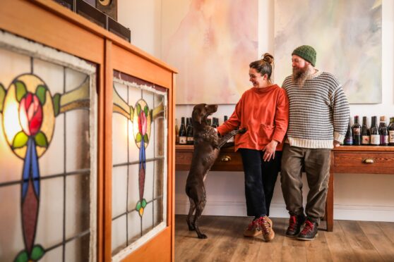 Nic and Stephen in their new shop and bar in Dundee with their dog Rita.