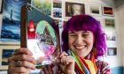 Holly-Jane grinning and holding up her award.