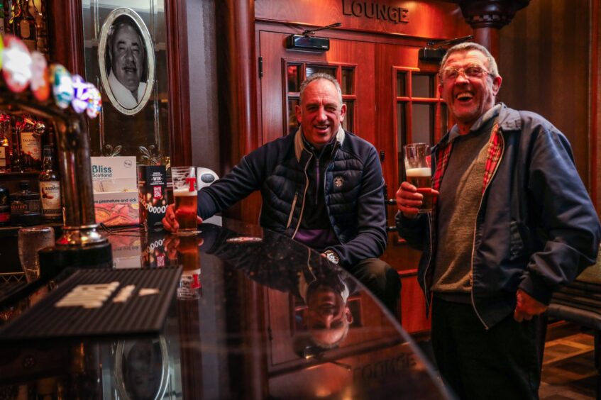 Smiling punters Andy McPherson and Raymond Boyd, one seated at the bar and the other standing, are regulars at The Fort. 
