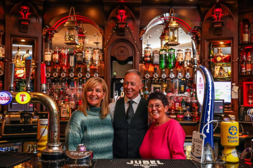 A family affair at The Fort with owners Marion, John and Carol Black standing behind the bar