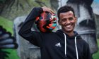 Naod Abraham holding a football. He arrived in Dundee as a lone child asylum seeker.