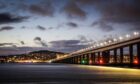 Scenic image of Dundee at nightfall with Taybridge and city lights.