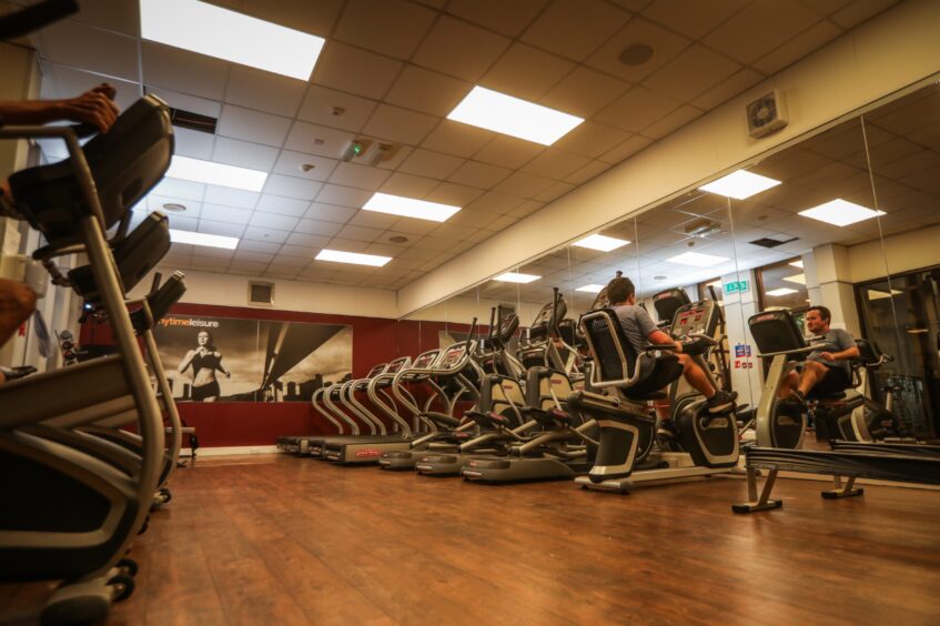 a man on an exercise bike in the Cardio section in the Woodlands Hotel gym. 