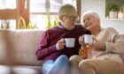 happy older couple smiling on sofa