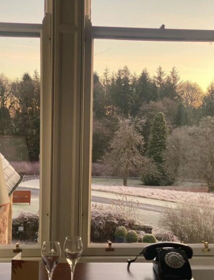The actress shared a photo of the view from her hotel room, which shows frost on the grass and trees 