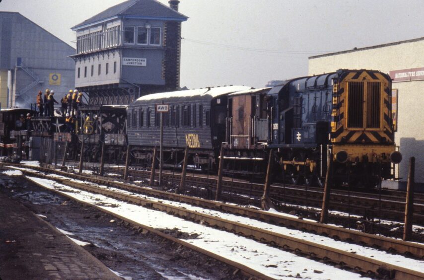 a crew beside a tunnel inspection train in 1980. 