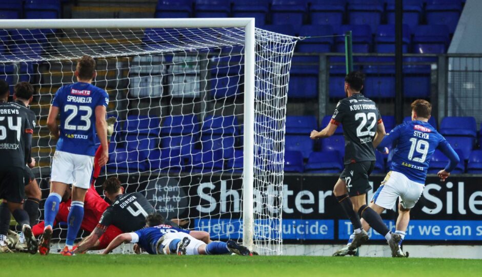 Taylor Steven slots the ball into the Motherwell net. 