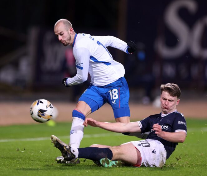 Dundee's Aaron Donnelly gets stuck in against Rangers dangerman Vaclav Cerny. Image: Kirk O'Rourke/Shutterstock