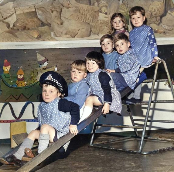 children going down the chute at Friarton Nursery. 