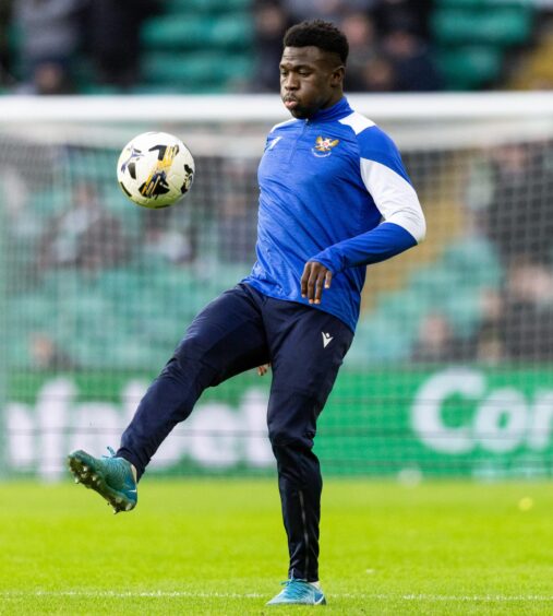 St Johnstone striker, Adama Sidibeh, warms up before a game against Celtic.