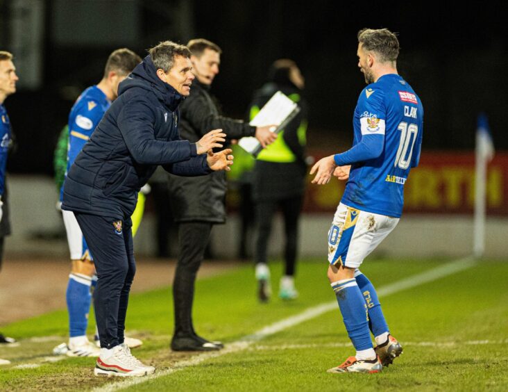 Nicky Clark speaks to Simo Valakari during a break in play in the St Johnstone v Hibs game.