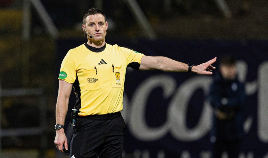 Referee Steven McLean points to the penalty spot in the Dundee derby 