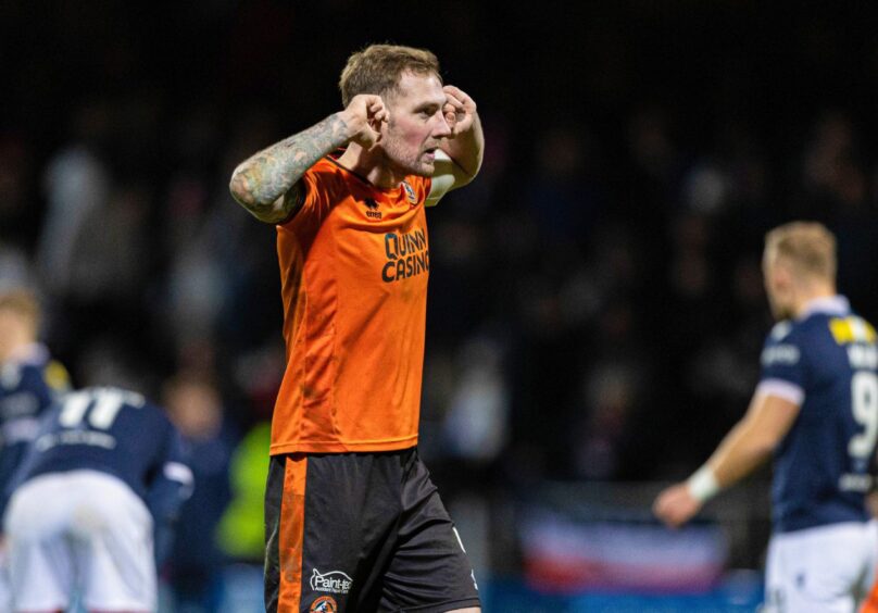 Dundee United's Kevin Holt laps up his assist for Sam Dalby