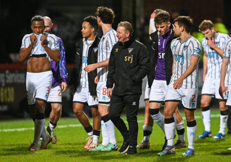 John McLaughlan is flanked by Dunfermline Athletic players as they walk off the pitch following a win over Partick Thistle.