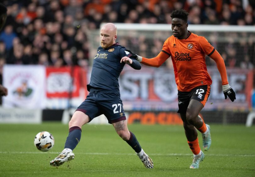 Hearts' Liam Boyce runs away from Dundee United's Richard Odada