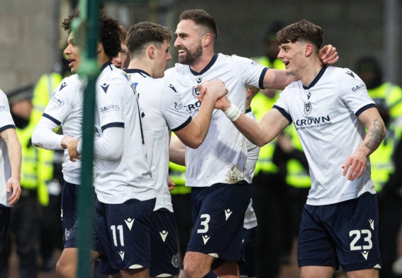 Dundee celebrate a crucial win. Image: Mark Scates/SNS