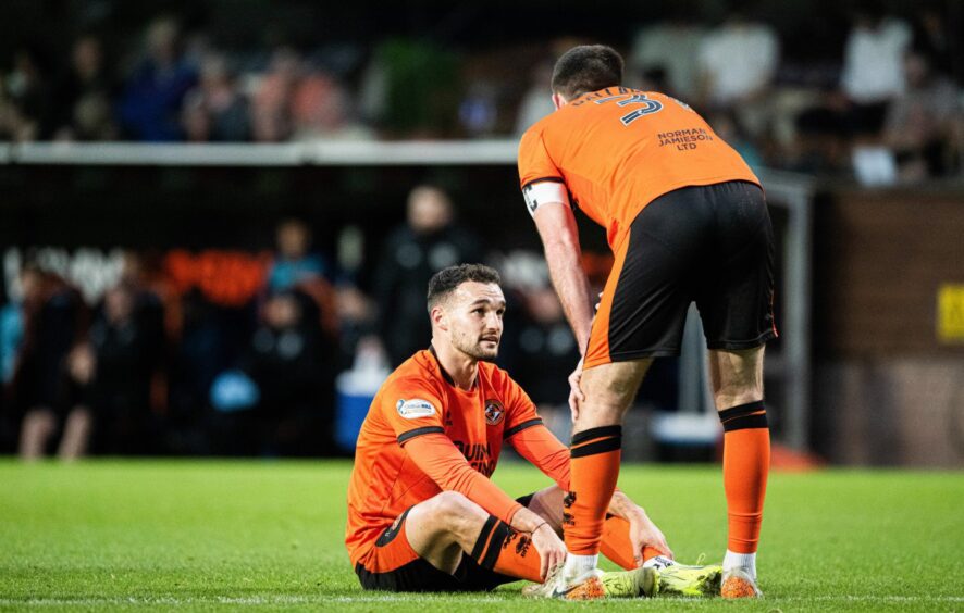 Dundee United's Vicko Sevelj after slumping to the turf with muscle soreness