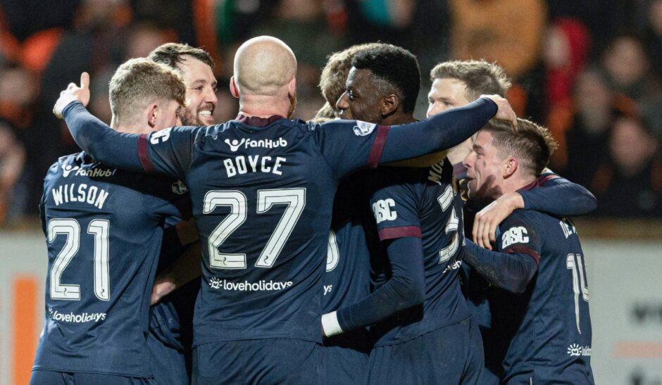 The Hearts players celebrate the only goal of the game