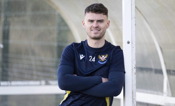 St Johnstone forward Josh McPake leans on a post for a photocall.