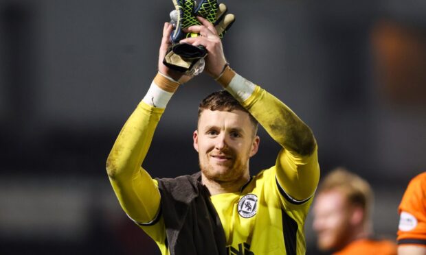 Jack Walton salutes the raucous United fans.