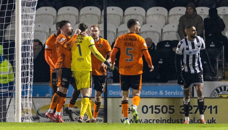 Jack Walton is saluted by his teammates after denying Toyosi Olusanya.