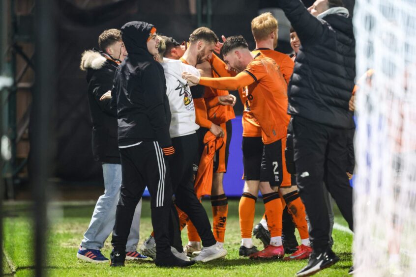 Louis Moult is surrounded by fans following his goal