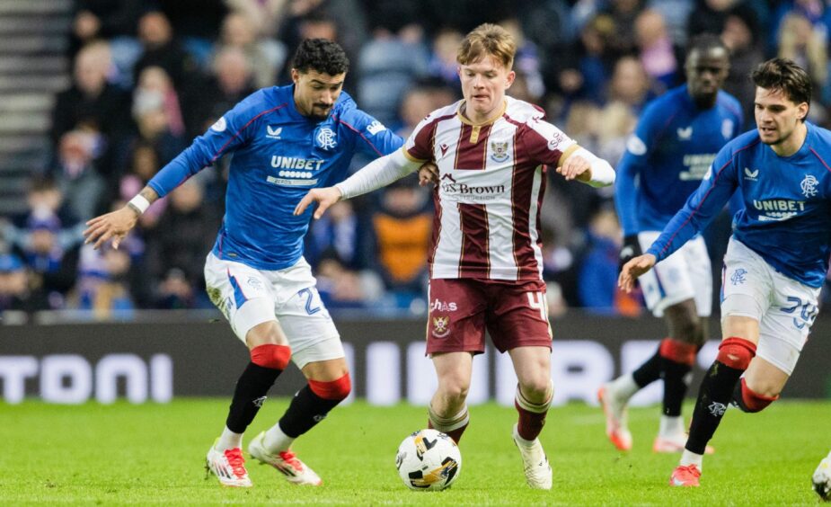 Fran Franczak drives forward between two Rangers players.