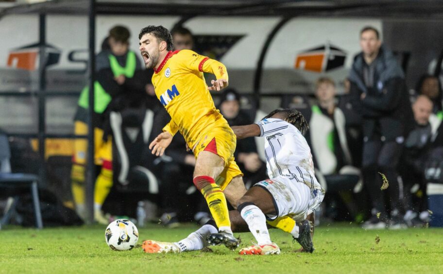 Ewan Otoo goes to ground in a tackle on Ayr opponent Nick McAllister.