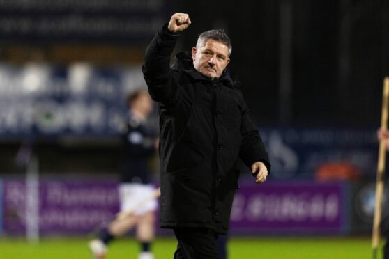 Dundee boss Tony Docherty salutes Dens Park fans after an impressive performance against Celtic. Image: Craig Foy/SNS