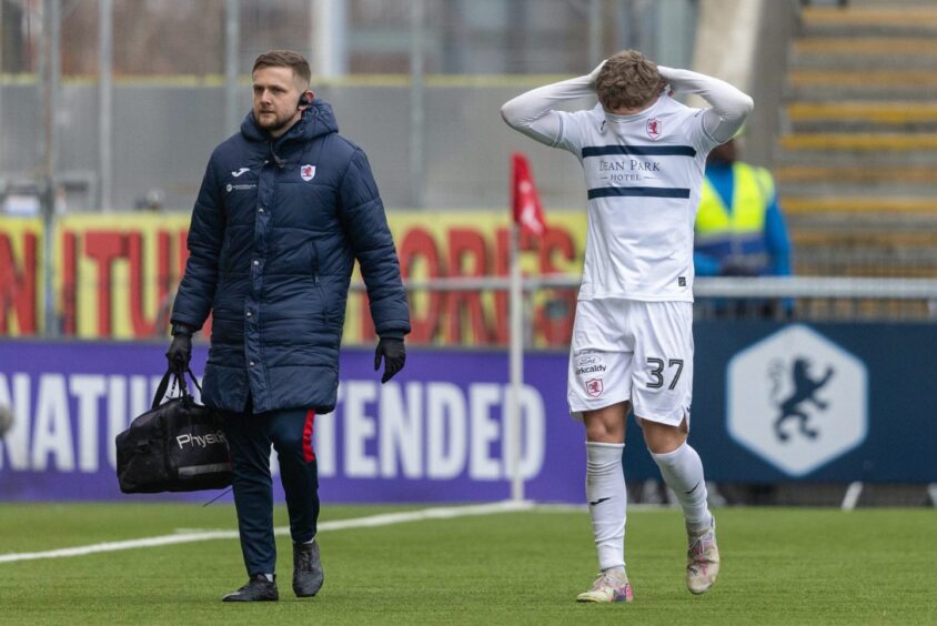 Aiden Marsh pulls his jersey up over his face as he trudges off the pitch at Falkirk.