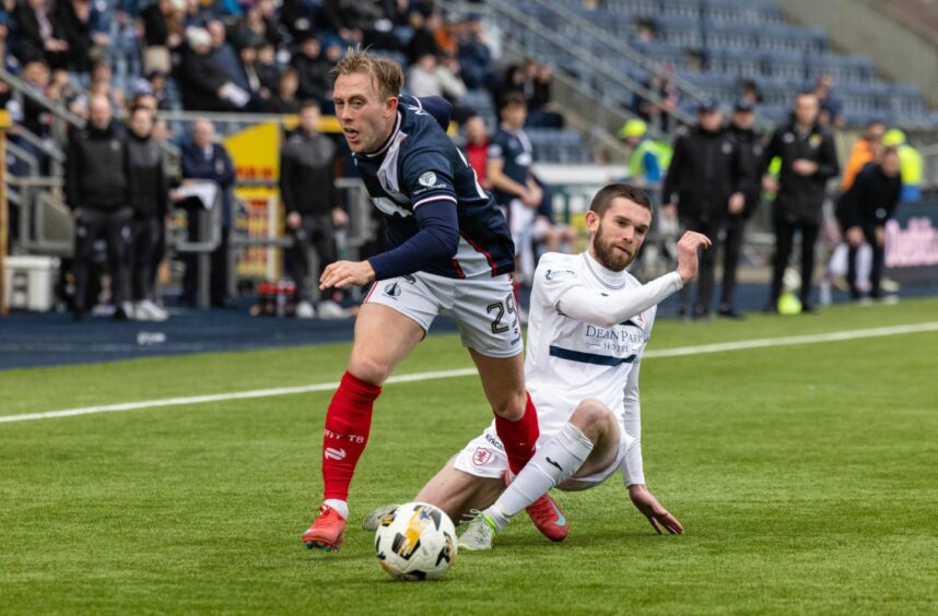 Raith's Sam Stanton tackles Falkirk opponent Calvin Miller.