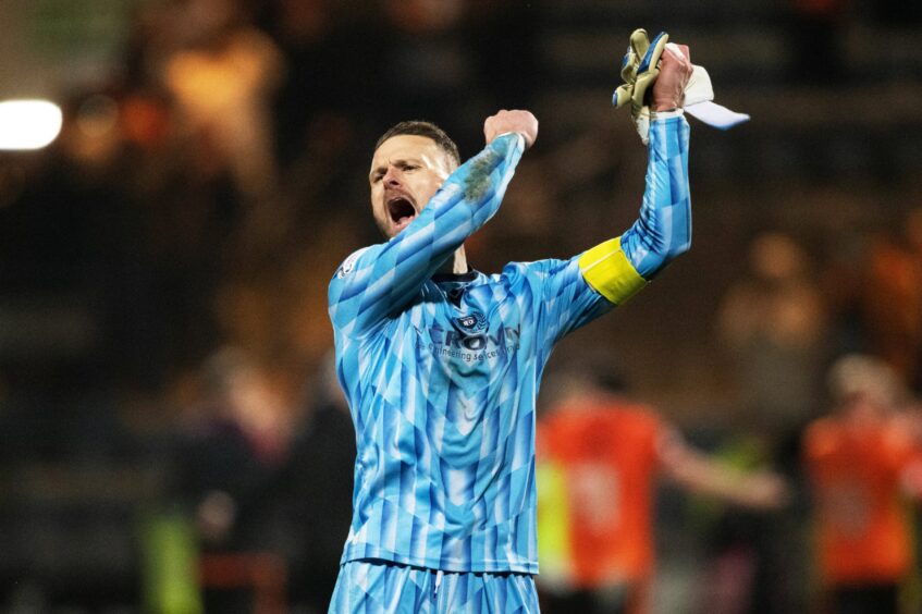 Carson salutes Dundee fans at Dens Park after a clean sheet in a derby victory. Image: Paul Devlin/SNS