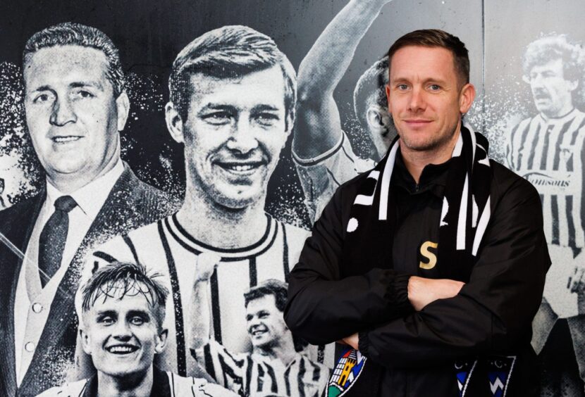 Michael Tidser stands beside a mural of Dunfermline Athletic F.C. players and managers.