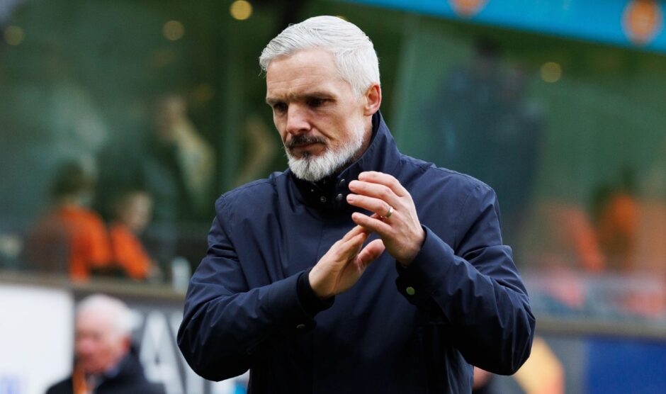 A dejected Jim Goodwin applauds the home fans