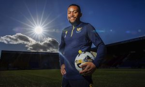 Victor Griffith holding a ball at McDiarmid Park for a photocall.