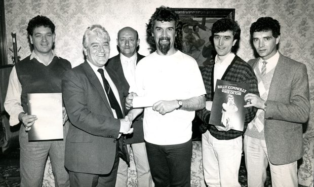 Billy Connolly receives the Lochee Live Aid cheque in 1985.