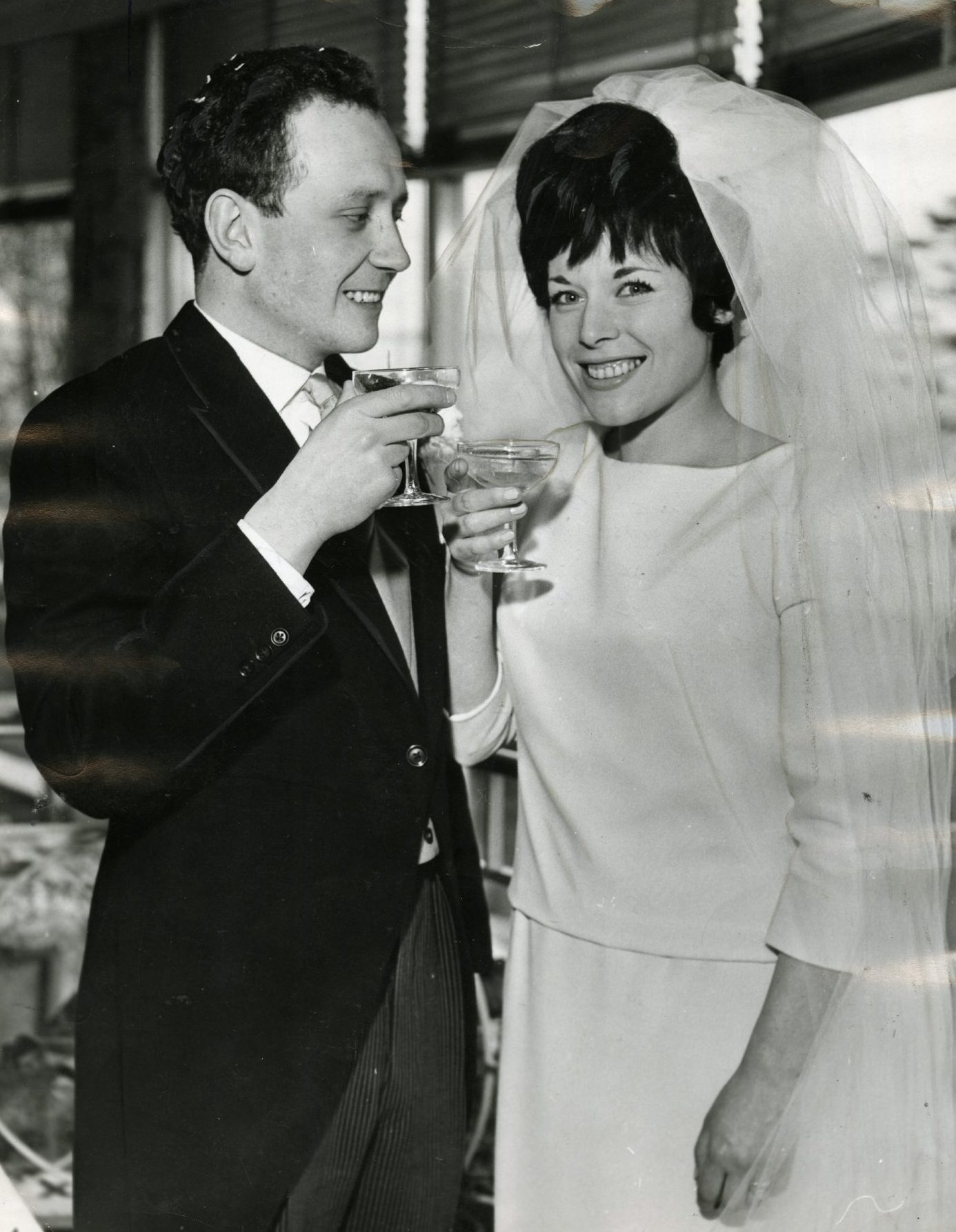 Jill Gascoine and Bill Keith raise a glass on their wedding day.