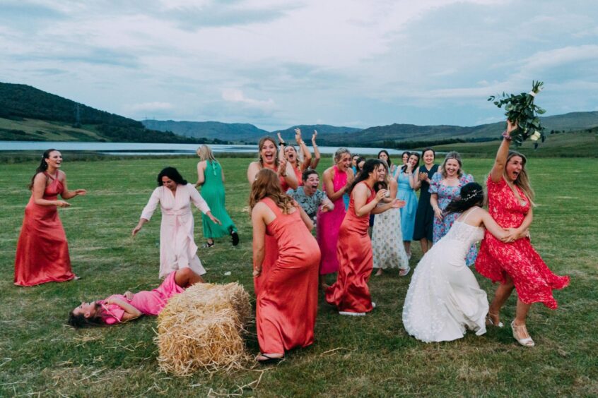 Women laughing as the bouquet is tossed