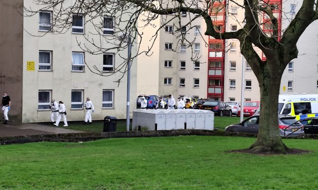 Forensics officers in white suits were seen entering the Broomhead Drive flats in Dunfermline. Image: Supplied