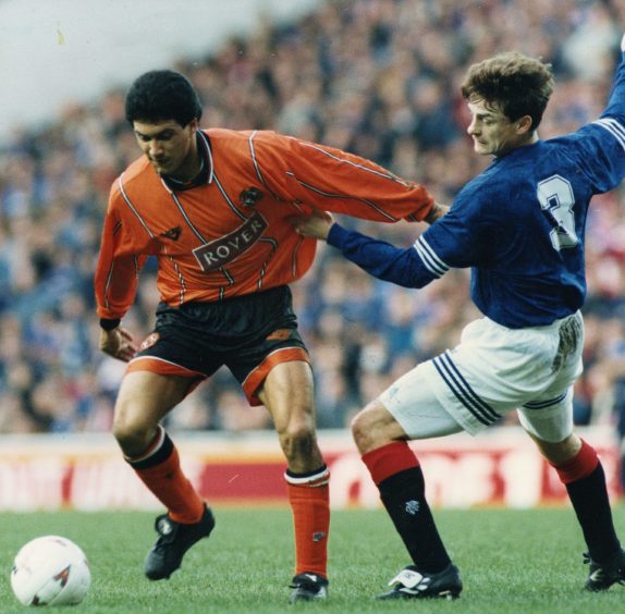 Sergio goes past David Robertson of Rangers at Ibrox.