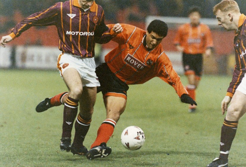 Sergio and a Motherwell player compete for the football