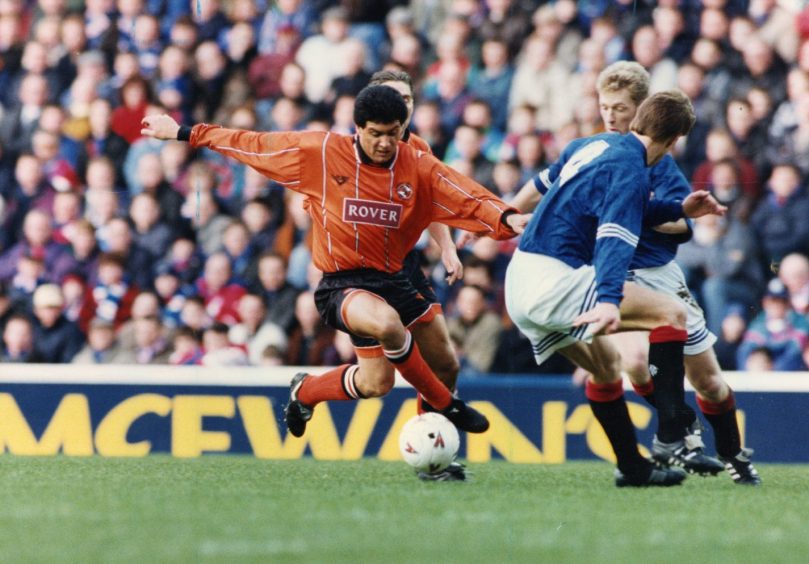 Sergio takes the ball past Craig Moore and Richard Gough at Ibrox.