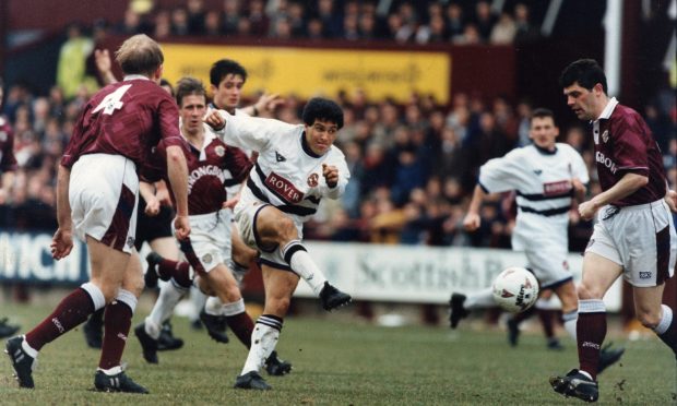 Sergio fires the ball through a crowd of players to score for Dundee United against Hearts in the Scottish Cup quarter-final.