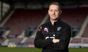 New Dunfermline Athletic head coach Michael Tidser stands with his arms folded at East End Park.