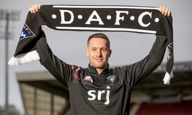 Michael Tidser holds up a Dunfermline Athletic F.C. scarf.