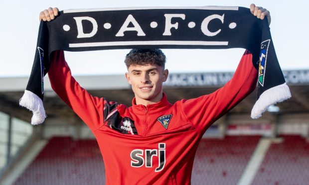 New Dunfermline Athletic loan signing Archie Stevens holds up a DAFC scarf.