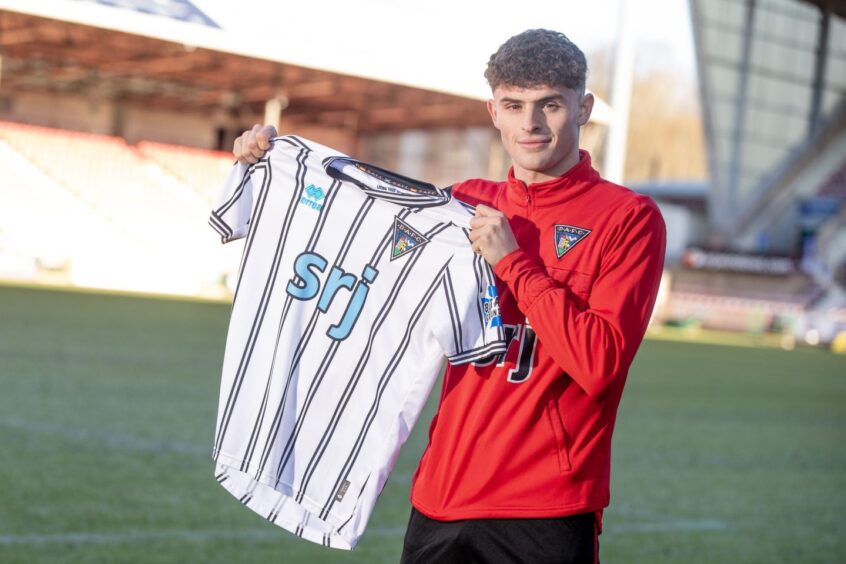 Archie Stevens holds up a Dunfermline strip at East End Park.